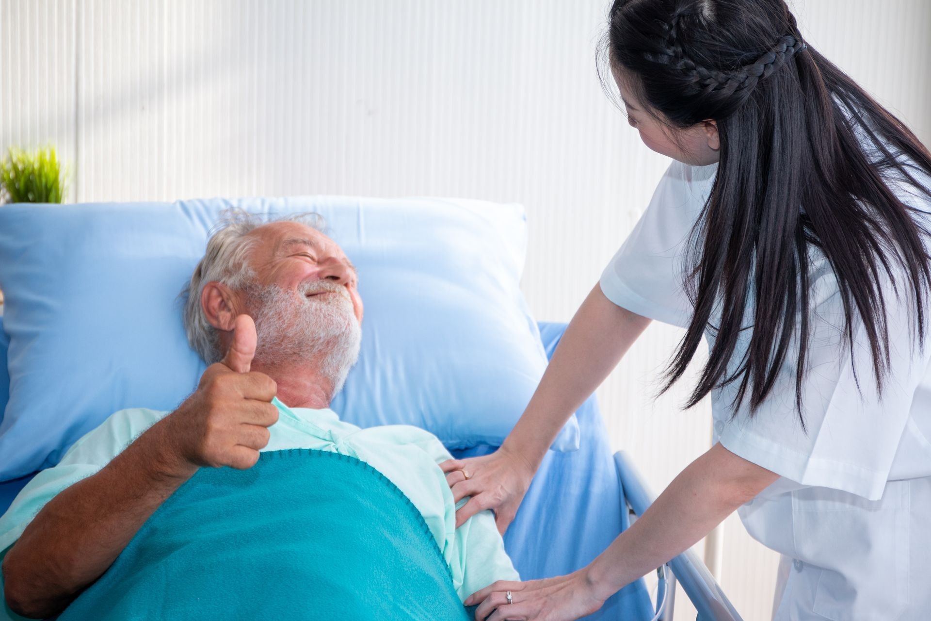 a old man or patient or elder sleeping on bed in hospital with doctor or nurse to take care and holding hands as health caring